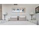 Bright bedroom featuring a plush bed, neutral decor, and bedside tables with lamps at 700 Beach Ne Dr # 704, St Petersburg, FL 33701