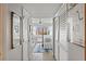 Hallway leading to the primary bedroom with white doors and wood floors at 700 Beach Ne Dr # 704, St Petersburg, FL 33701