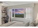 Bedroom featuring a large window with sunset water view and a built-in desk at 700 Beach Ne Dr # 704, St Petersburg, FL 33701