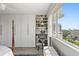 Bedroom featuring a large window with city and water view, built-in desk and shelving at 700 Beach Ne Dr # 704, St Petersburg, FL 33701