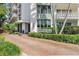 Well-maintained exterior of Harbour Hill with palm trees and updated landscaping at 700 Beach Ne Dr # 704, St Petersburg, FL 33701