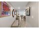 Bright hallway featuring bench seating, art, and tile floors leading to the dining area at 700 Beach Ne Dr # 704, St Petersburg, FL 33701