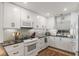 Cozy kitchen showcases stainless steel appliances, white cabinets and unique backsplash at 700 Beach Ne Dr # 704, St Petersburg, FL 33701