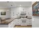 Bright kitchen features white cabinets, black hardware, granite counters and stainless steel appliances at 700 Beach Ne Dr # 704, St Petersburg, FL 33701