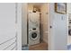 Stacked washer and dryer unit with shelving for storage at 700 Beach Ne Dr # 704, St Petersburg, FL 33701
