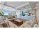 Open living room with a coffered ceiling, built-in cabinets, and a view of the balcony at 700 Beach Ne Dr # 704, St Petersburg, FL 33701