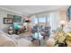 Cozy living room with a wall of art and a view to the balcony at 700 Beach Ne Dr # 704, St Petersburg, FL 33701