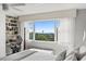 Bedroom featuring a large window with water view and a built-in desk at 700 Beach Ne Dr # 704, St Petersburg, FL 33701