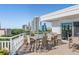 Rooftop deck with multiple tables and chairs, with panoramic city views and blue skies at 700 Beach Ne Dr # 704, St Petersburg, FL 33701