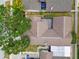 Overhead view of a single-story house, showcasing the roofline, landscaping, and surrounding properties at 7035 Drury St, Tampa, FL 33635