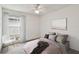 Bright bedroom features a ceiling fan, large window and neutral paint, creating a soothing space at 7035 Drury St, Tampa, FL 33635