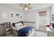 Bright bedroom featuring nautical themed decor and a comfortable bed with a blue quilt at 7035 Drury St, Tampa, FL 33635