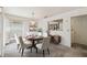 Elegant dining room featuring a round table, chandelier and direct access to the living area at 7035 Drury St, Tampa, FL 33635