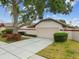 Charming home featuring a well-manicured front yard and a spacious driveway with mature trees at 7035 Drury St, Tampa, FL 33635