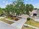 Inviting single-story home featuring lush landscaping, well-kept lawn, and a paved driveway at 7035 Drury St, Tampa, FL 33635