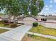 Charming single-story home with neutral paint, attached garage, and mature landscaping at 7035 Drury St, Tampa, FL 33635