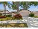 Charming single-story home featuring mature landscaping and a two-car garage at 7035 Drury St, Tampa, FL 33635