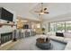 Bright living room featuring fireplace, bar seating, and sliding glass doors at 7035 Drury St, Tampa, FL 33635