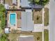 Aerial view of a home showcasing the backyard pool, patio area, detached shed, and well-maintained landscaping at 8497 Portulaca Ave, Seminole, FL 33777