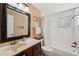 Bright bathroom with tiled shower/tub and a wooden vanity at 8497 Portulaca Ave, Seminole, FL 33777