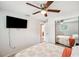 A bedroom with a television, mirrored closet, and neutral decor at 8497 Portulaca Ave, Seminole, FL 33777