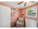 A cozy Bedroom featuring a chair, changing table, and bookshelves at 8497 Portulaca Ave, Seminole, FL 33777