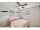 Cozy bedroom with ceiling fan, natural light and wood-look flooring at 8497 Portulaca Ave, Seminole, FL 33777