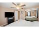 Bedroom featuring a television, mirrored closet, and neutral walls at 8497 Portulaca Ave, Seminole, FL 33777