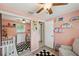 Charming bedroom features a large closet with mirrors, a comfy chair, and a cute crib, creating a welcoming space at 8497 Portulaca Ave, Seminole, FL 33777