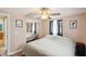 A bedroom with a mirrored closet, fan, and neutral walls at 8497 Portulaca Ave, Seminole, FL 33777
