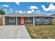 Delightful single-Gathering home featuring fresh landscaping, a concrete driveway and a cheerful front entrance at 8497 Portulaca Ave, Seminole, FL 33777