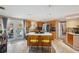 Bright kitchen with oak cabinets, stainless appliances, a large island with seating, and access to the outdoor pool area at 8497 Portulaca Ave, Seminole, FL 33777