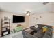 Spacious living area with a large sectional, a mounted television, and neutral wall colors at 8497 Portulaca Ave, Seminole, FL 33777