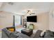 Comfortable living room features a plush sectional sofa, ceiling fan and a large flat screen television at 8497 Portulaca Ave, Seminole, FL 33777