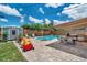 Inviting backyard with a sparkling pool, outdoor dining area, shed, and lush landscaping perfect for entertaining at 8497 Portulaca Ave, Seminole, FL 33777
