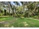 Lush green backyard features mature trees offering both beauty and shade at 8562 Acorn Ridge Ct, Tampa, FL 33625
