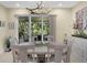 Bright dining room with views of the lush backyard through sliding glass doors at 8562 Acorn Ridge Ct, Tampa, FL 33625