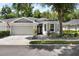 Inviting single-story home featuring a well-maintained lawn and an attached two-car garage at 8562 Acorn Ridge Ct, Tampa, FL 33625