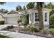 Charming home boasts a lovely front yard with mature landscaping and a sunny bay window at 8562 Acorn Ridge Ct, Tampa, FL 33625