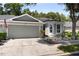 Charming single Gathering home with a two-car garage, landscaped front yard, and an American flag displayed at 8562 Acorn Ridge Ct, Tampa, FL 33625