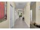 Inviting hallway with neutral walls, tile flooring, and a view of the home's living spaces beyond at 8562 Acorn Ridge Ct, Tampa, FL 33625