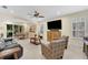 Bright and airy living room with tile floors and ample seating, perfect for entertaining guests at 8562 Acorn Ridge Ct, Tampa, FL 33625