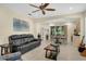 Cozy living room with tile floors, comfortable seating, and an adjacent dining area for easy entertaining at 8562 Acorn Ridge Ct, Tampa, FL 33625