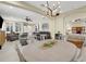 Open concept living area with a modern chandelier and views of the bedroom and dining room at 8562 Acorn Ridge Ct, Tampa, FL 33625
