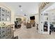 Spacious living room featuring tile flooring, comfortable seating, and a large flat-screen television at 8562 Acorn Ridge Ct, Tampa, FL 33625