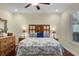 Relaxing main bedroom with a wood headboard and neutral color palette at 8562 Acorn Ridge Ct, Tampa, FL 33625
