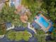 Aerial view of the community pool, parking, and natural green spaces at 8562 Acorn Ridge Ct, Tampa, FL 33625