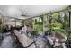 Relaxing screened-in porch with comfortable seating and view of the landscaped backyard at 8562 Acorn Ridge Ct, Tampa, FL 33625