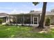 View of the screened-in porch with a ceiling fan overlooking the spacious backyard at 8562 Acorn Ridge Ct, Tampa, FL 33625