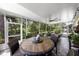 Spacious screened porch with ceiling fan and dining area, perfect for outdoor dining at 8562 Acorn Ridge Ct, Tampa, FL 33625